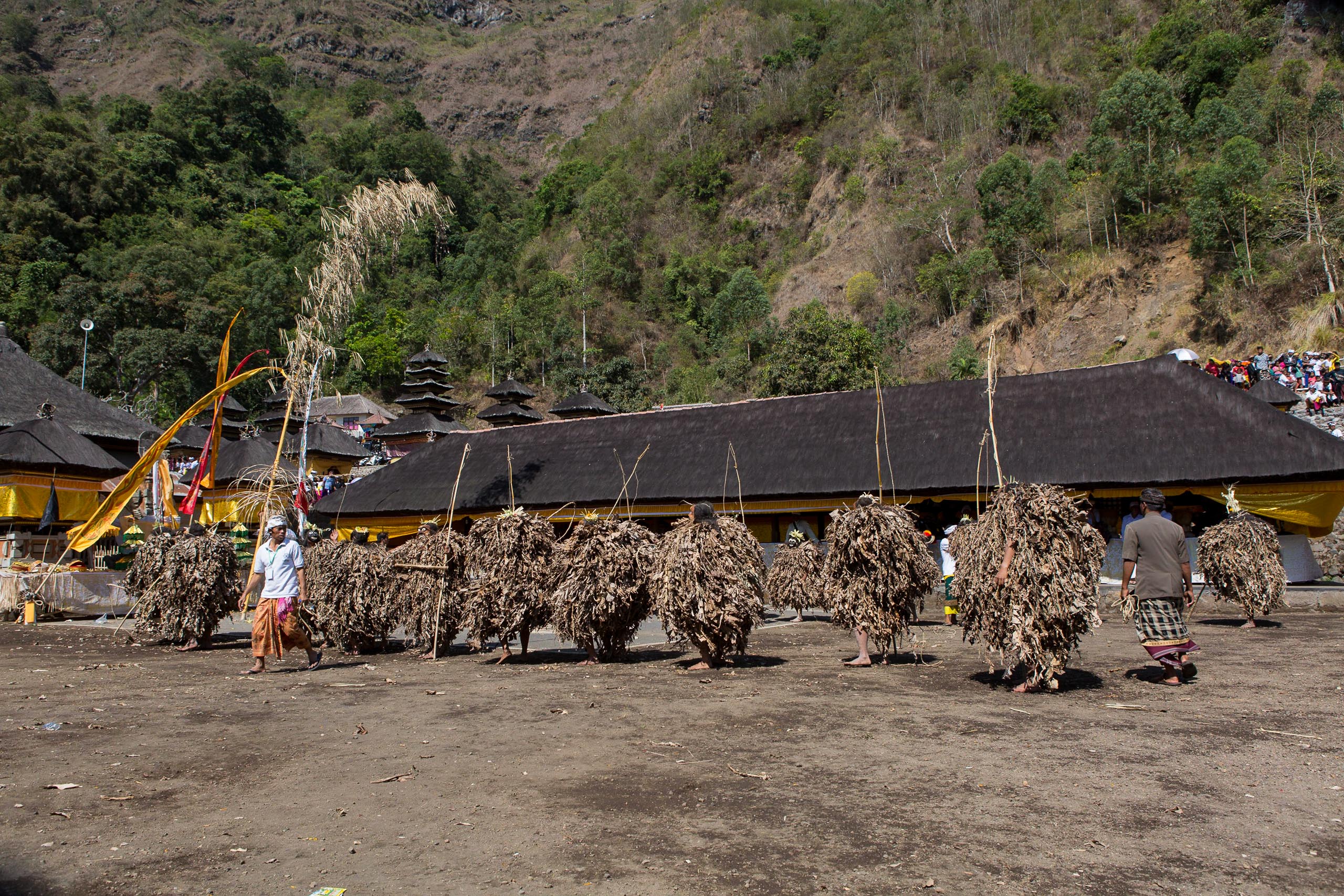 Barong Brutuk dancers performing in temple courtyard Trunyan Bali