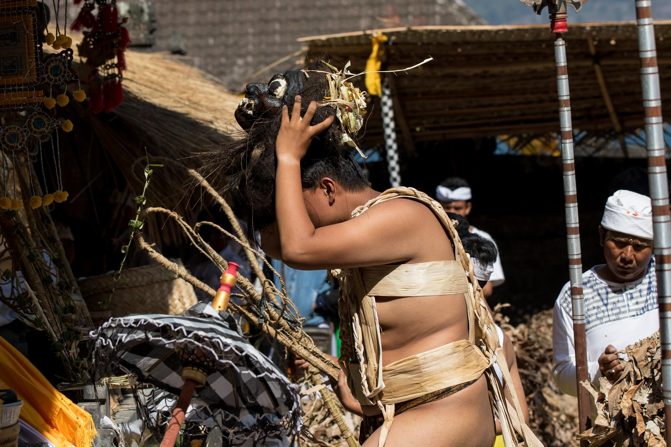 Young man preparing Barong Brutuk banana leaf costume in Trunyan village
