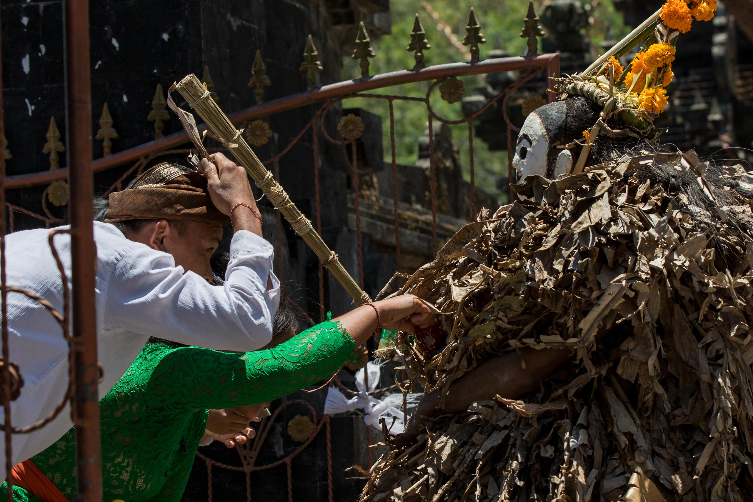 Barong Brutuk dancer giving ritual blessing with whip in Trunyan