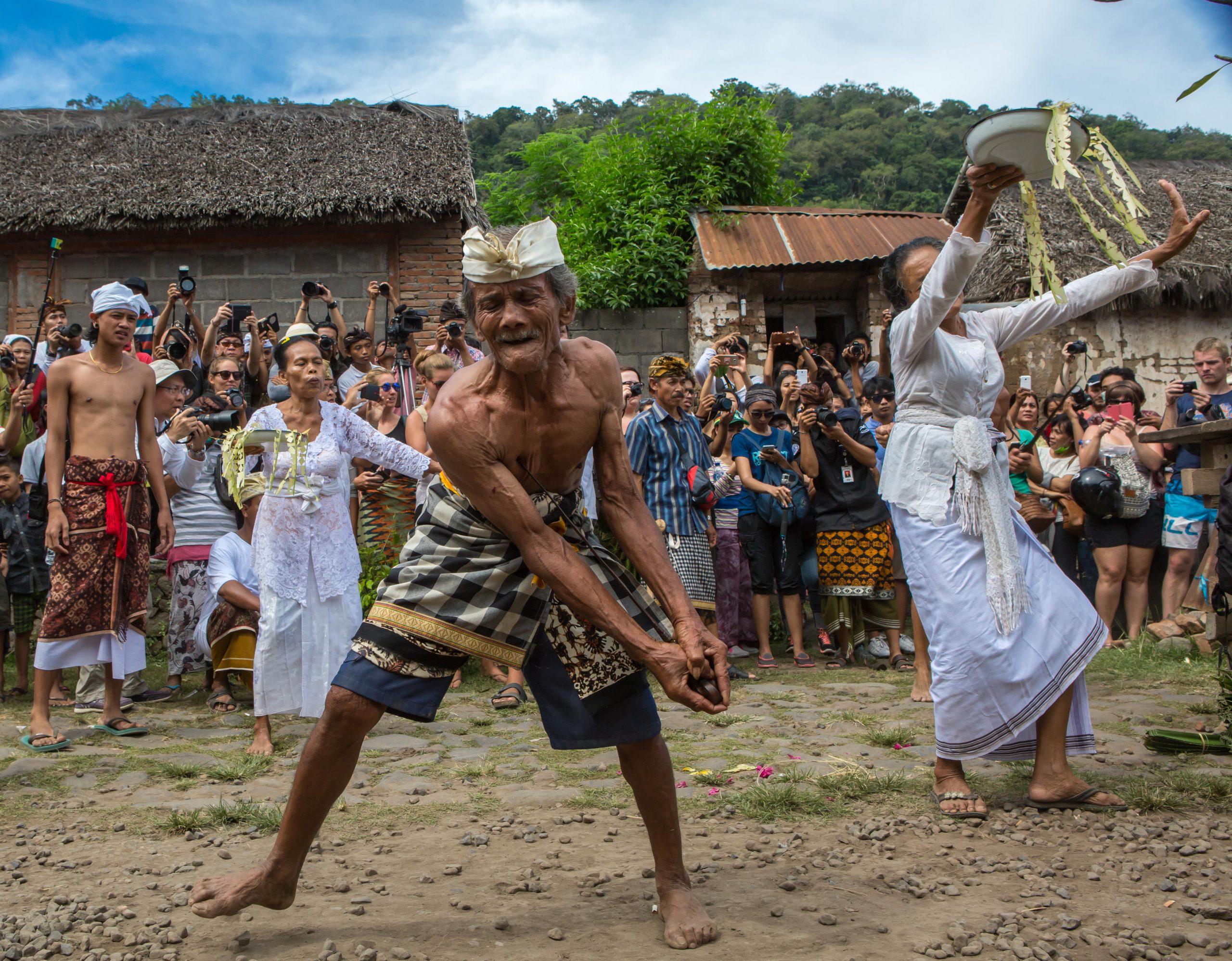 Balinese man in trance performing ngurek keris ritual during Mekare-kare ceremony